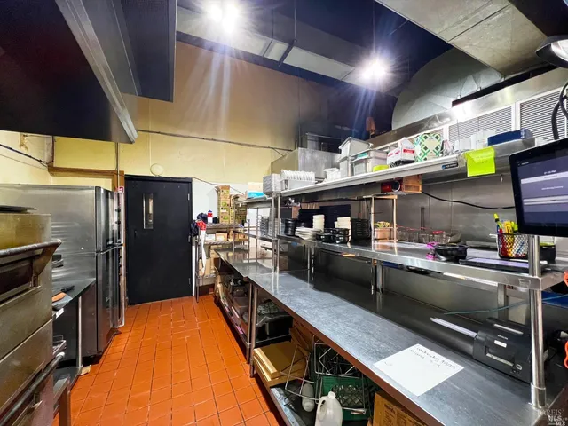 a kitchen with stainless steel appliances lots of counter space and a window