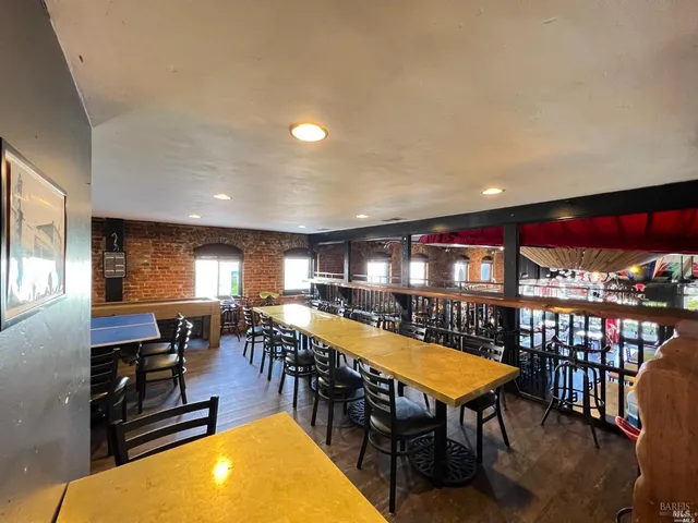 a room with furniture pool table and windows