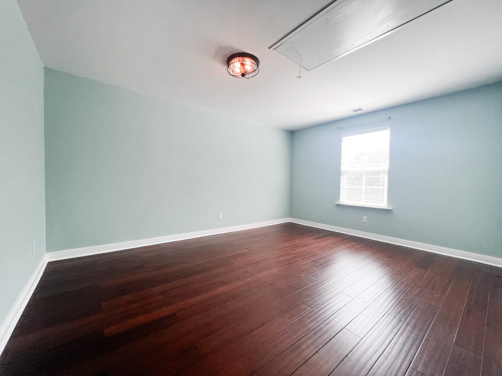 10848 Newtown Road Rockvale, TN 37153 - Photo 20 of 28 an empty room with wooden floor and windows