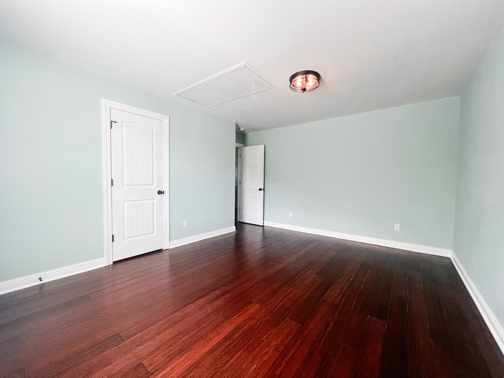 10848 Newtown Road Rockvale, TN 37153 - Photo 21 of 28 an empty room with wooden floor and windows