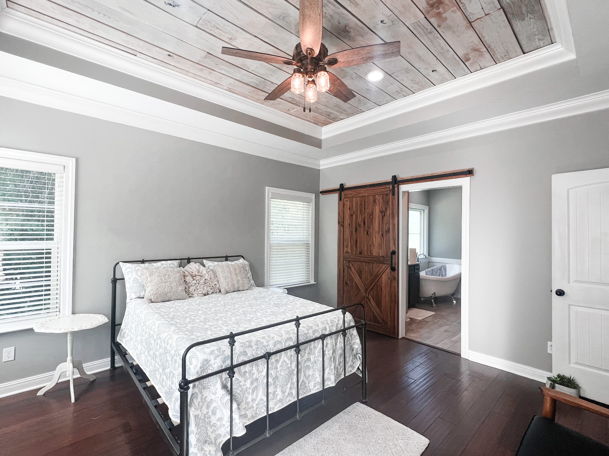 10848 Newtown Road Rockvale, TN 37153 - Photo 9 of 28 a spacious bedroom with a bed and a chandelier