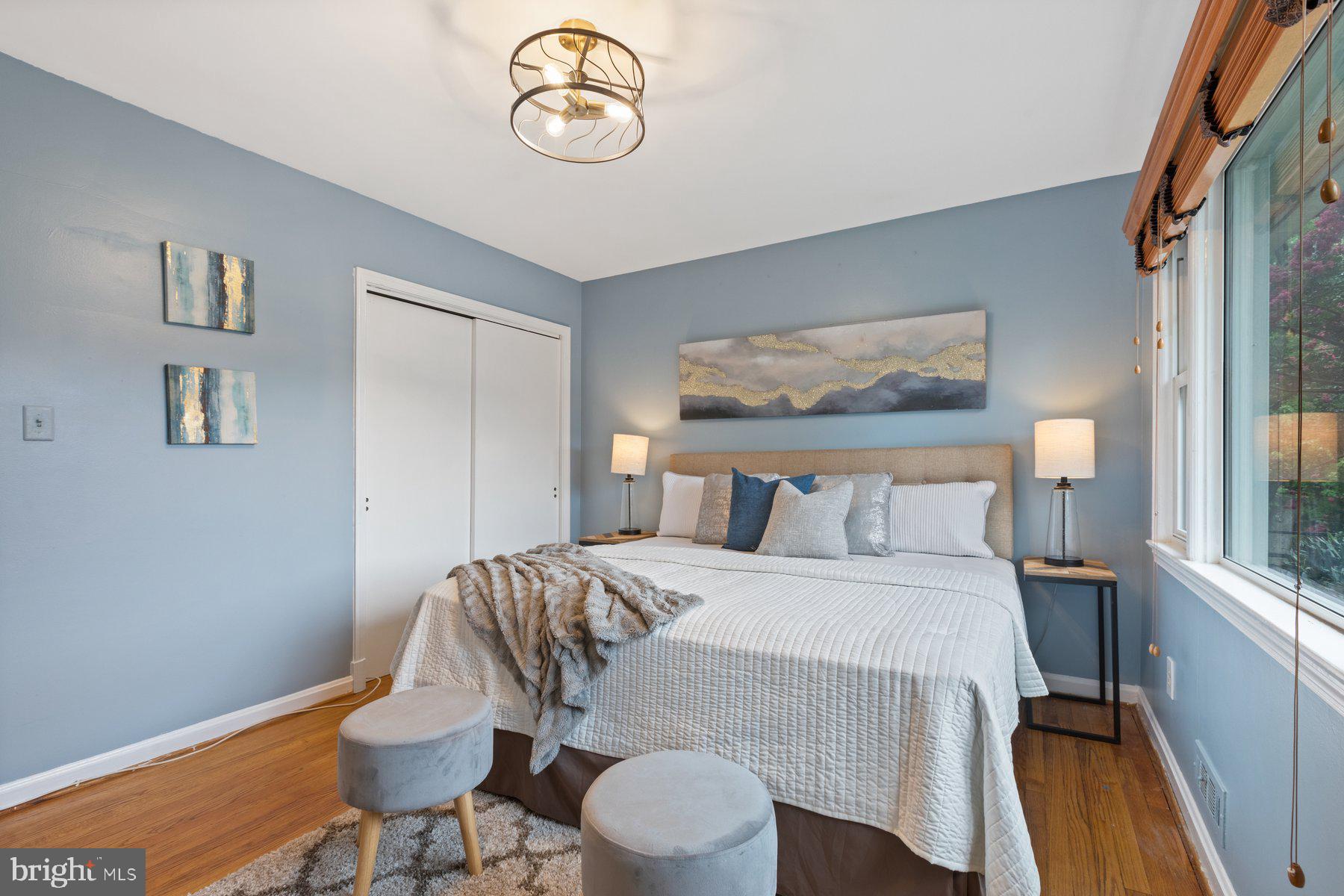 2605 Eccleston Street Silver Spring, MD 20902 - Photo 14 of 47 a bedroom with a bed and a chandelier