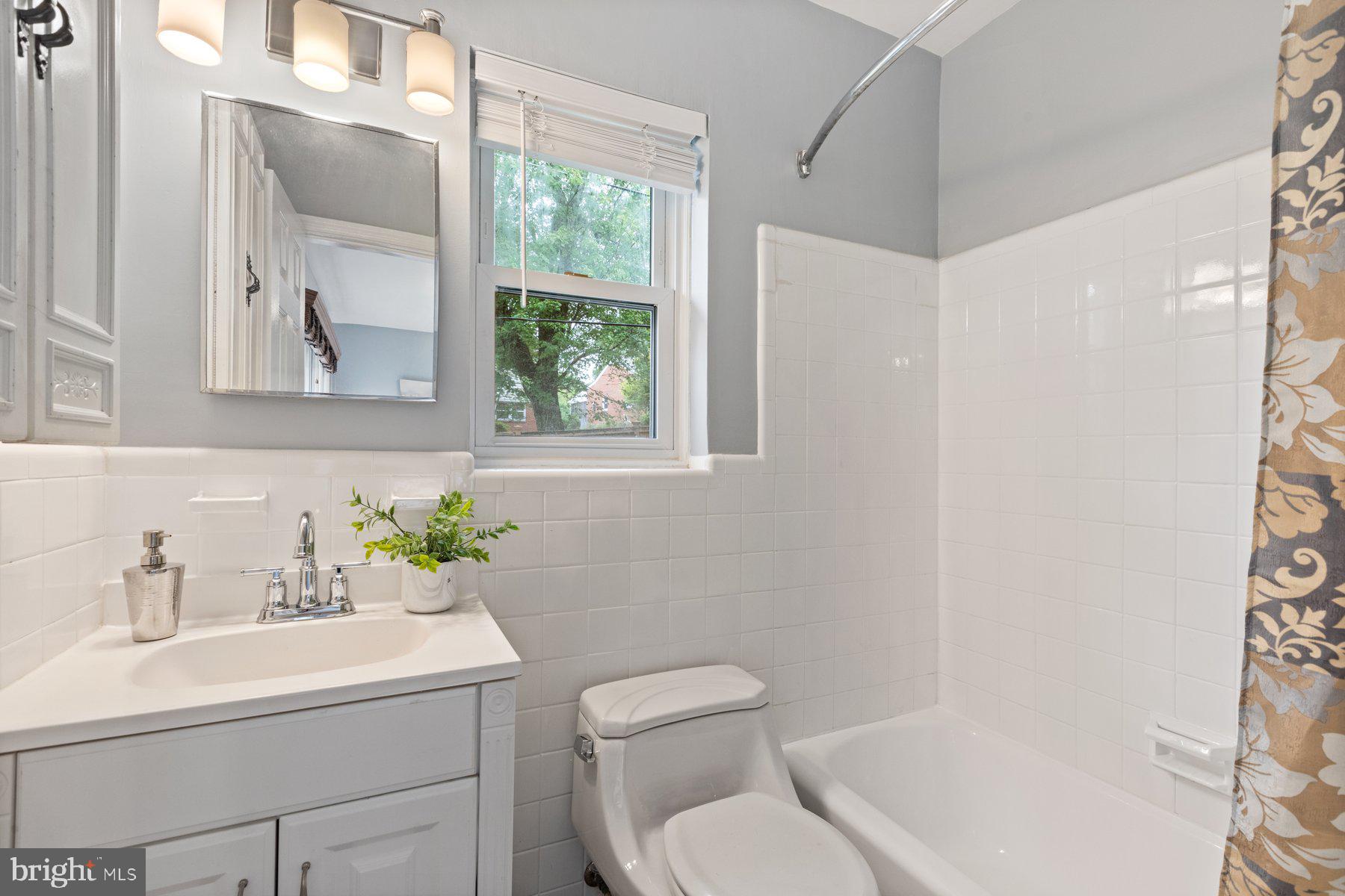 2605 Eccleston Street Silver Spring, MD 20902 - Photo 15 of 47 a bathroom with a sink toilet and tub