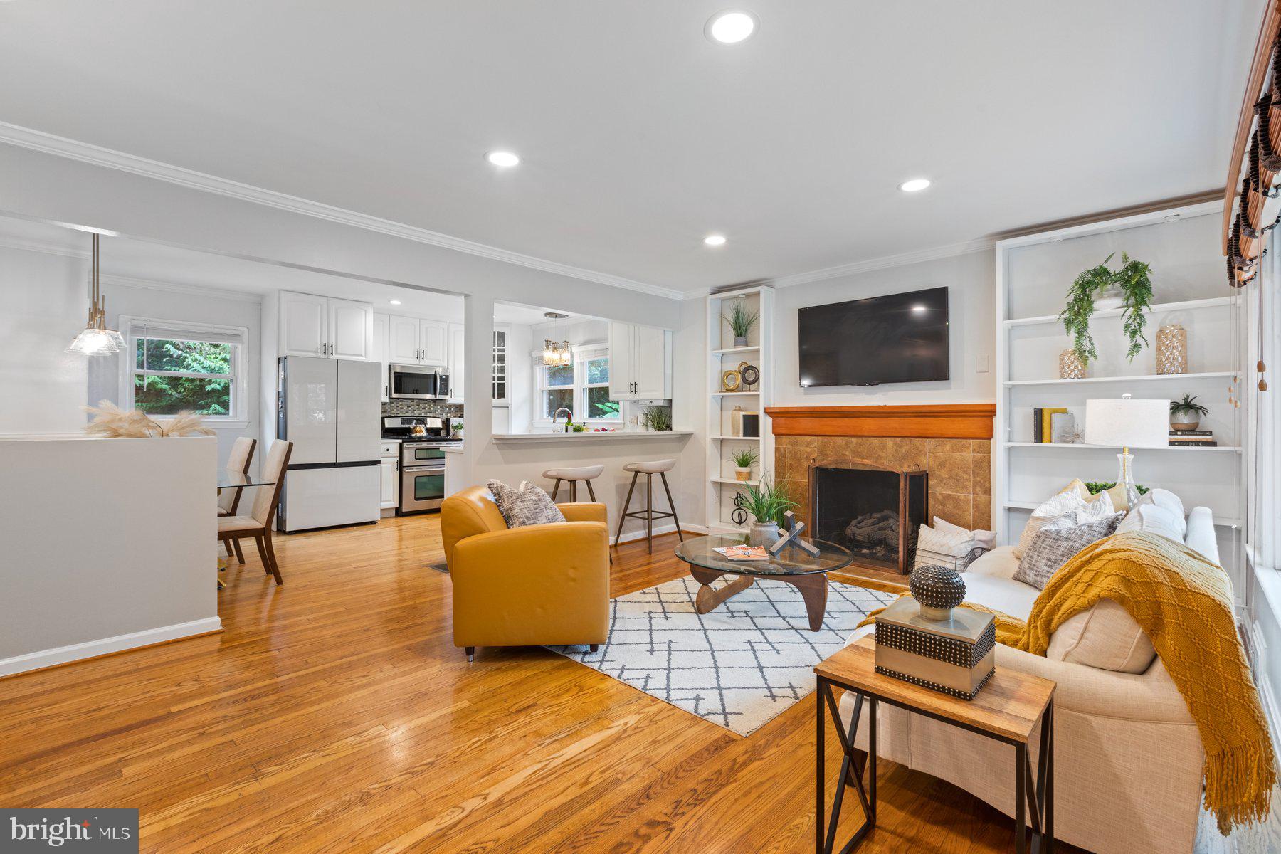 2605 Eccleston Street Silver Spring, MD 20902 - Photo 4 of 47 a living room with furniture a fireplace and a flat screen tv