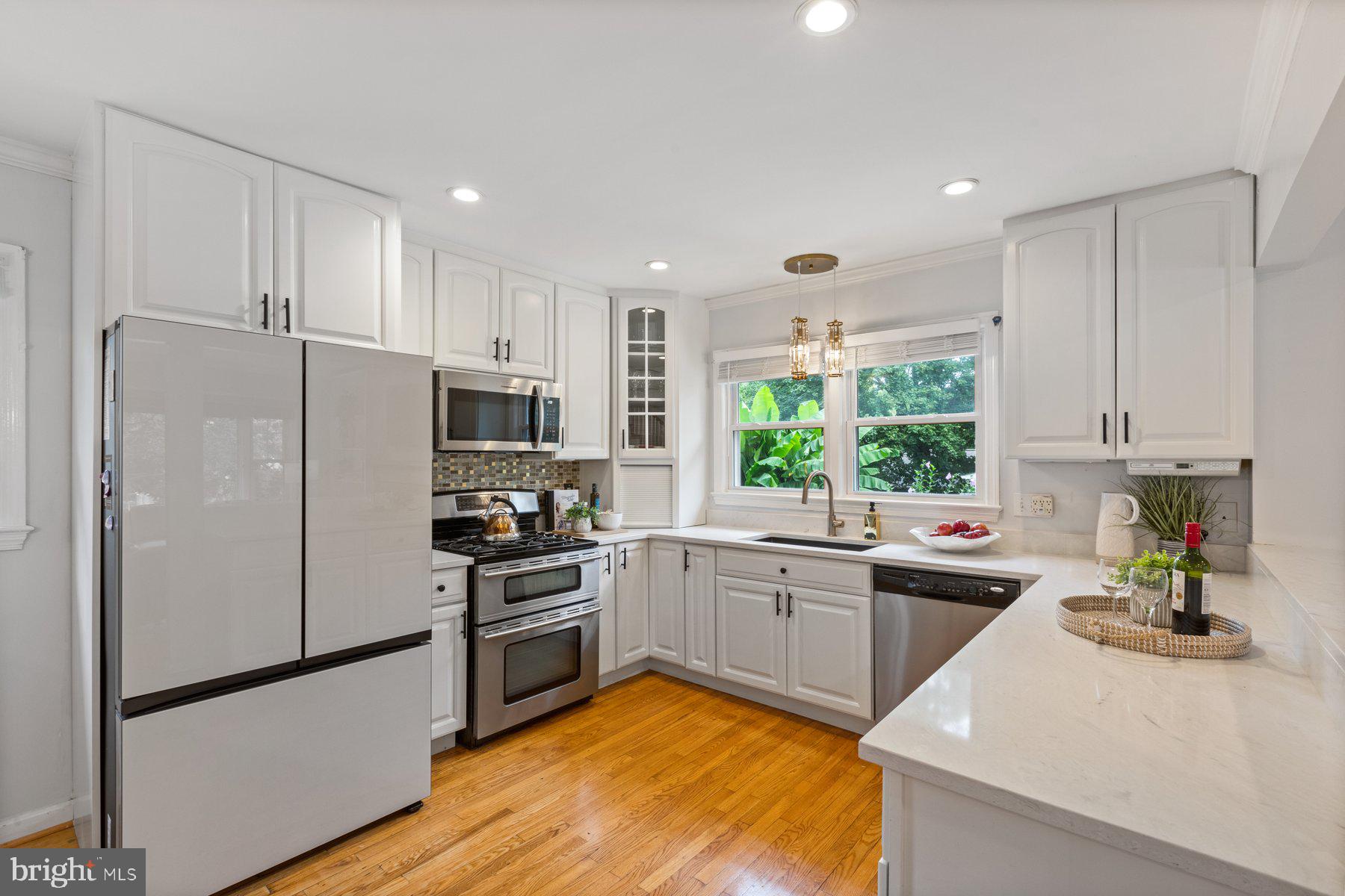 2605 Eccleston Street Silver Spring, MD 20902 - Photo 6 of 47 a kitchen with a sink a counter top space stainless steel appliances and cabinets
