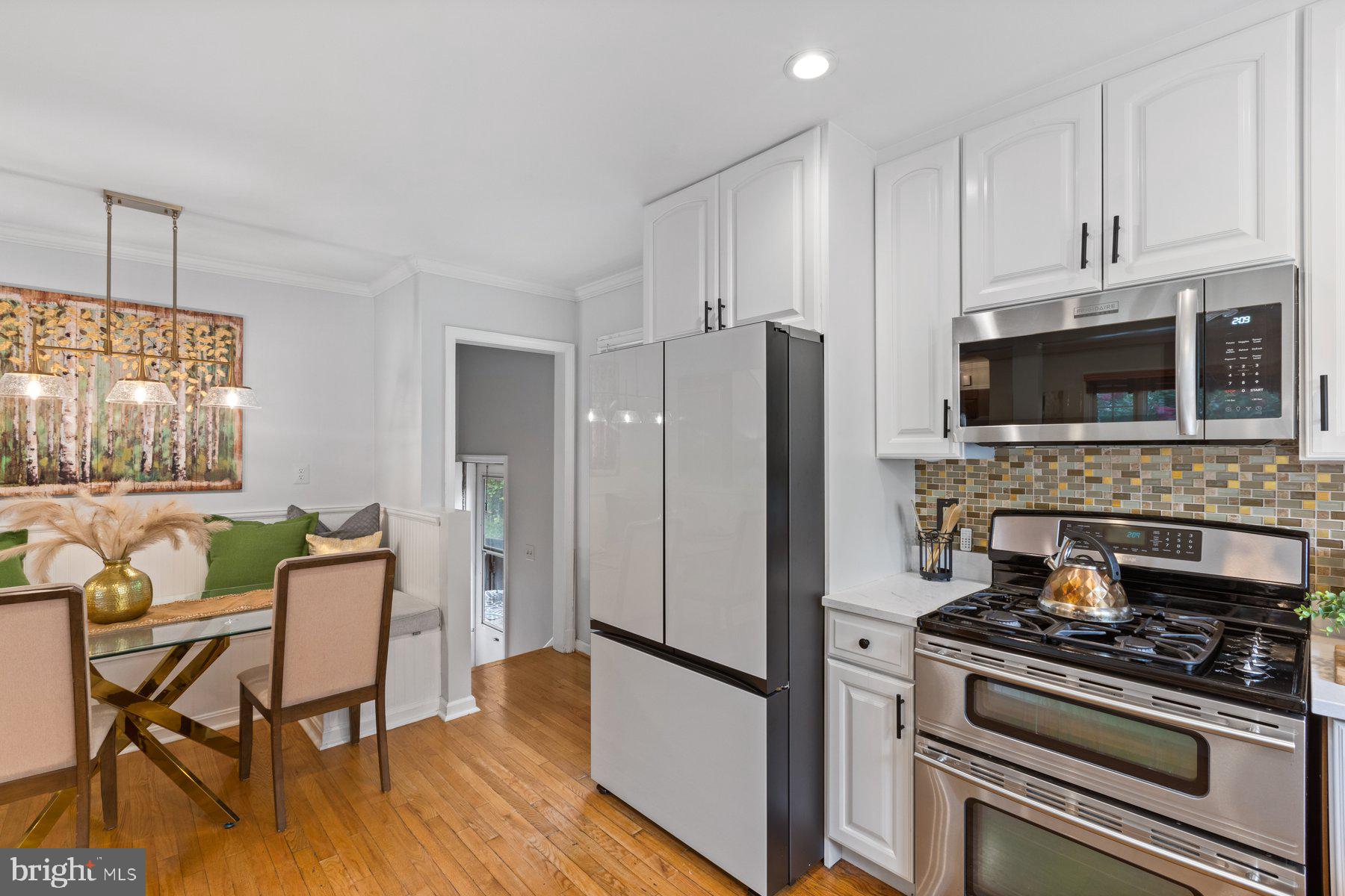 2605 Eccleston Street Silver Spring, MD 20902 - Photo 8 of 47 a kitchen with stainless steel appliances a stove a refrigerator and a microwave