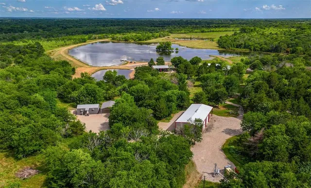 an aerial view of a house with a garden and a yard
