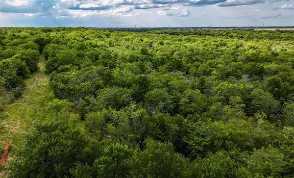 an aerial view of a house with a yard and lake view