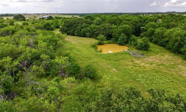 a view of water with a yard