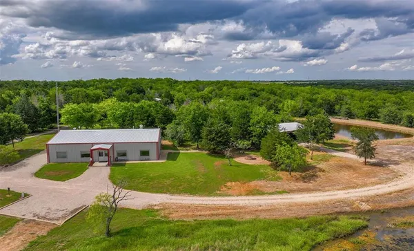a aerial view of a house with swimming pool and garden