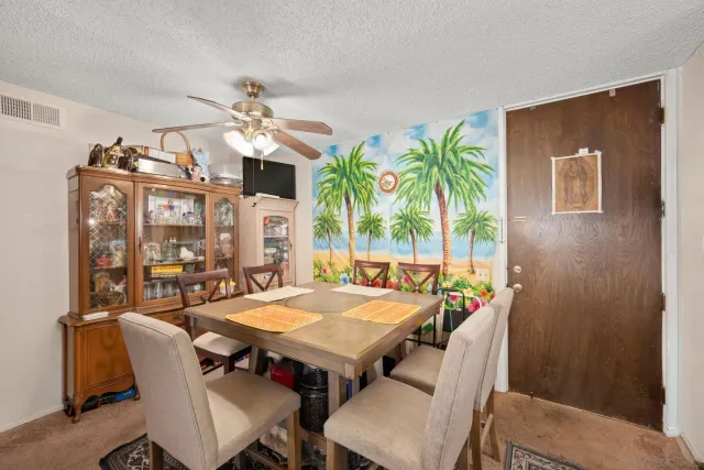 a dining room with furniture a rug and wooden floor