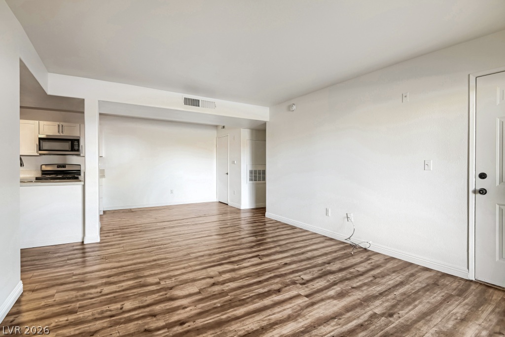 7885 West Flamingo Road, Unit 1003 Las Vegas, NV 89147 - Photo 8 of 22 Gleaming wood-look floors anchor this versatile living space connecting seamlessly to the kitchen.
