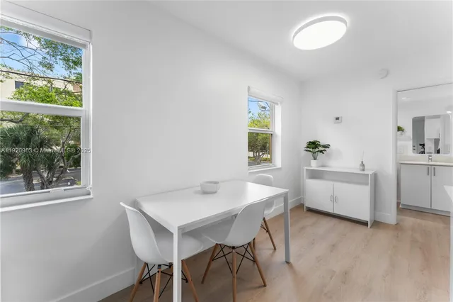 a view of a dining room with furniture and window
