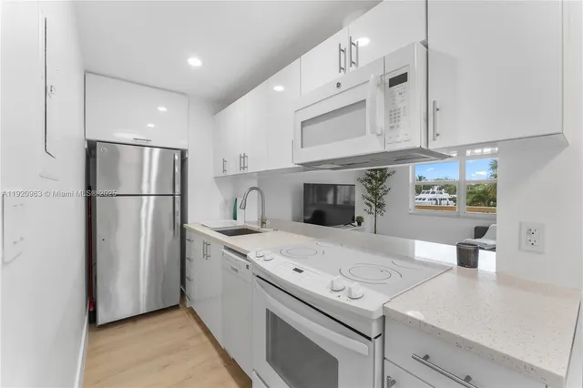 a kitchen with stainless steel appliances granite countertop a refrigerator sink and cabinets
