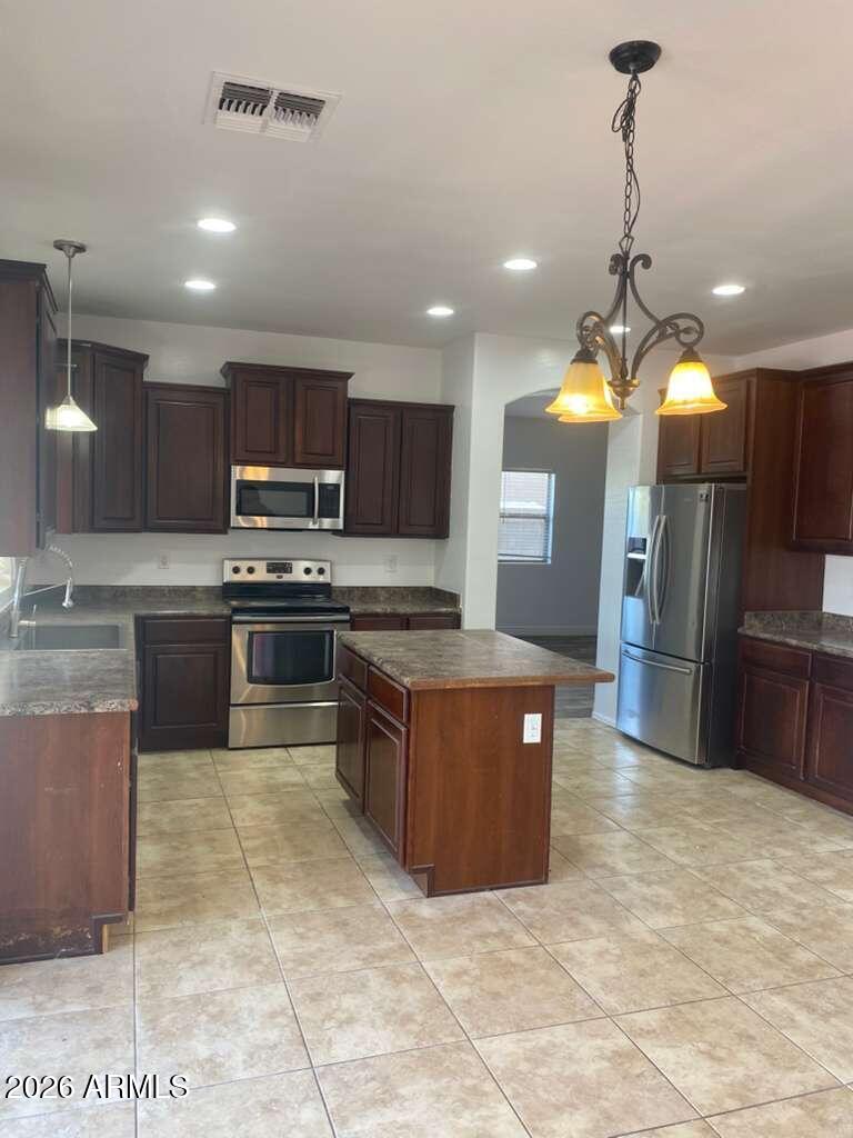 9677 Barley Road Florence, AZ 85132 - Photo 12 of 22 a kitchen with stainless steel appliances granite countertop a stove a sink a refrigerator and a microwave