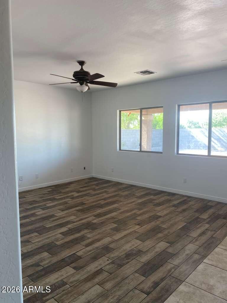 9677 Barley Road Florence, AZ 85132 - Photo 13 of 22 an empty room with windows and ceiling fan