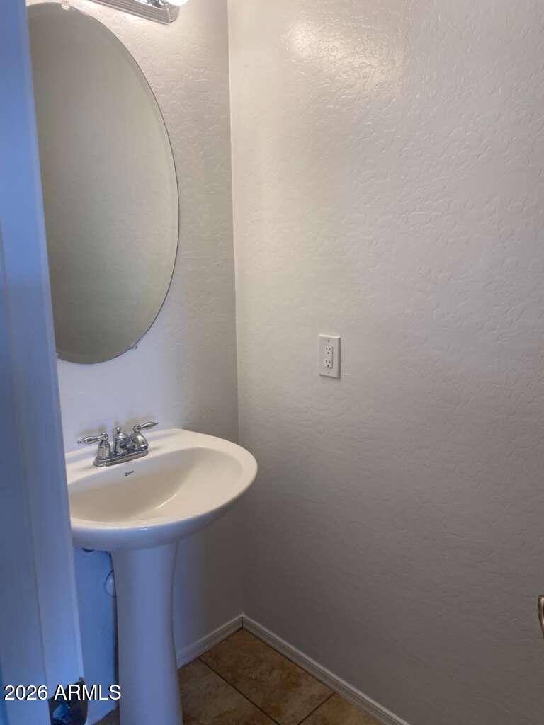 9677 Barley Road Florence, AZ 85132 - Photo 15 of 22 a bathroom with a sink a mirror and vanity