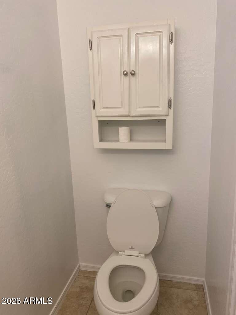 9677 Barley Road Florence, AZ 85132 - Photo 17 of 22 a white toilet sitting next to a bathroom sink