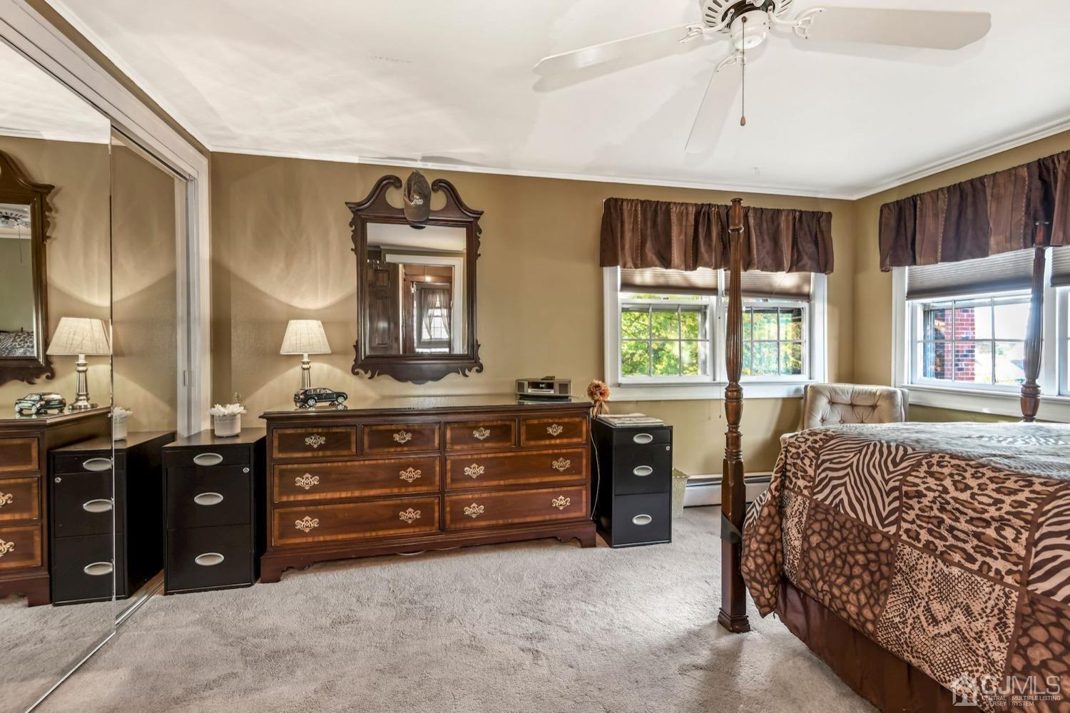 390 Cliff Road Sewaren, NJ 07077 - Photo 20 of 32 a spacious bedroom with a bed and a dresser
