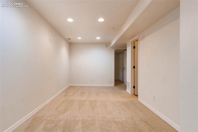 9231 Ballybunion Road Peyton, CO 80831 - Photo 20 of 26 Basement family room looking back to bedroom door.