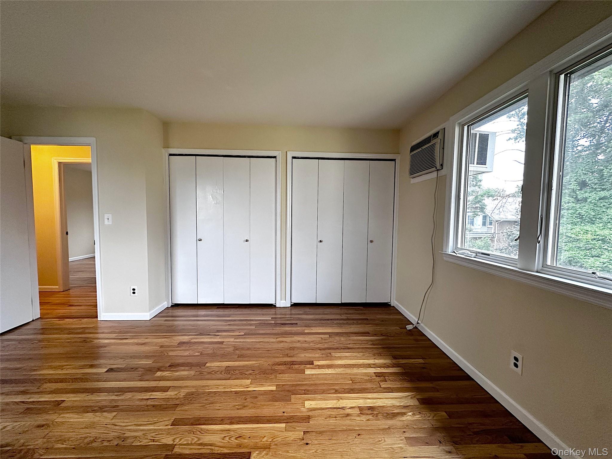 25 Acacia Terrace, Unit 2 New Rochelle, NY 10805 - Photo 12 of 28 a view of an empty room with wooden floor and a window