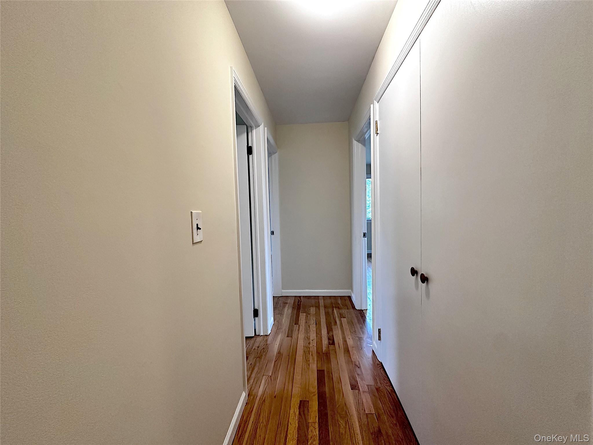 25 Acacia Terrace, Unit 2 New Rochelle, NY 10805 - Photo 14 of 28 a view of a hallway with wooden floor and a bathroom