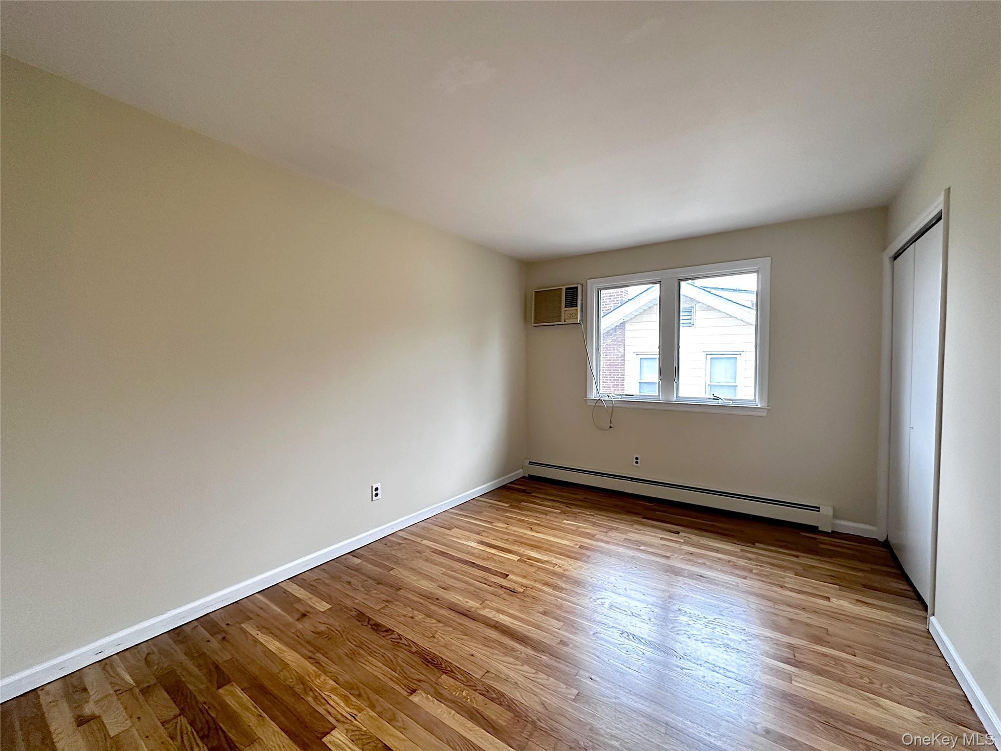 25 Acacia Terrace, Unit 2 New Rochelle, NY 10805 - Photo 15 of 28 an empty room with wooden floor and windows