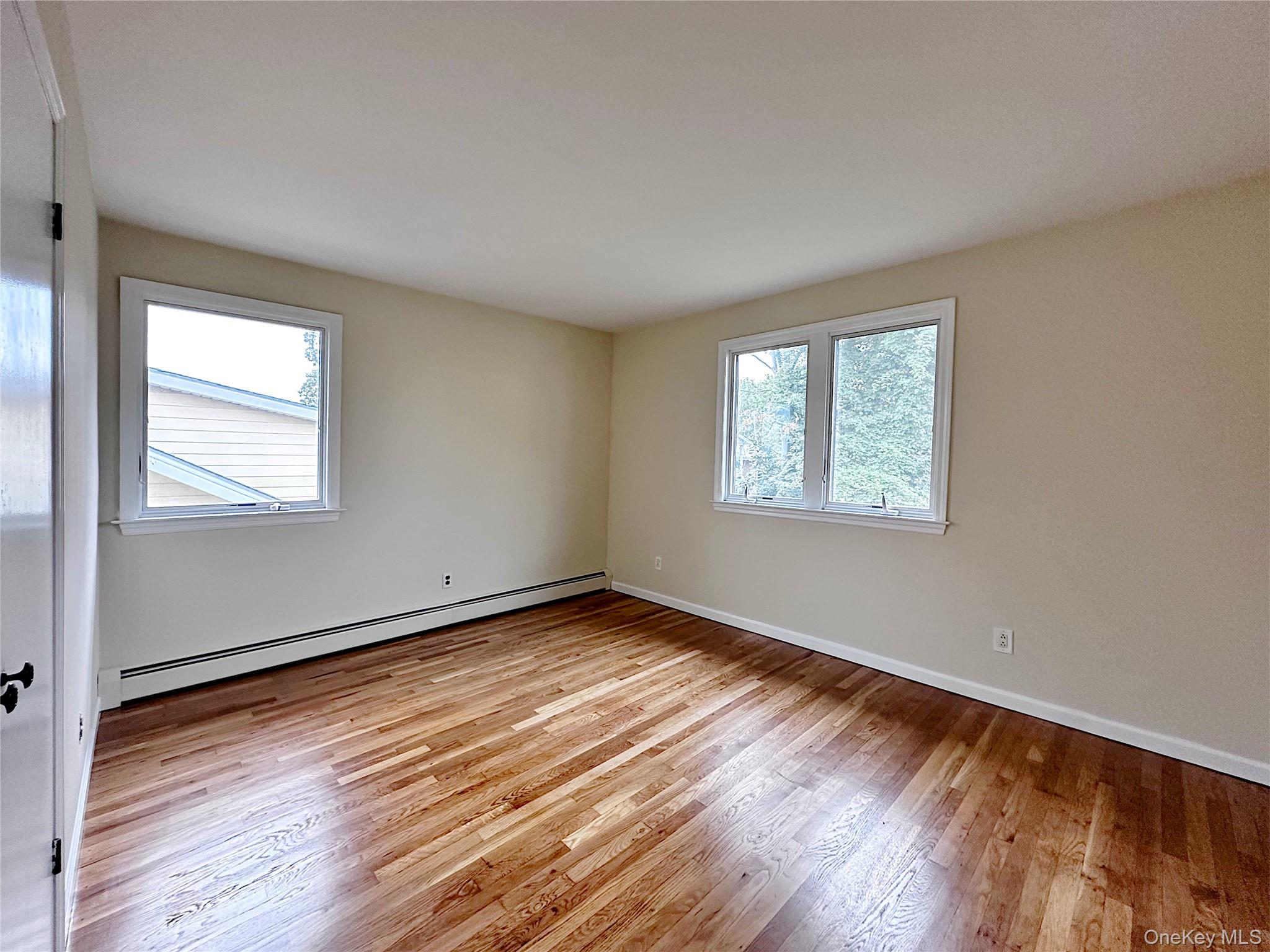 25 Acacia Terrace, Unit 2 New Rochelle, NY 10805 - Photo 17 of 28 a view of an empty room with wooden floor and a window