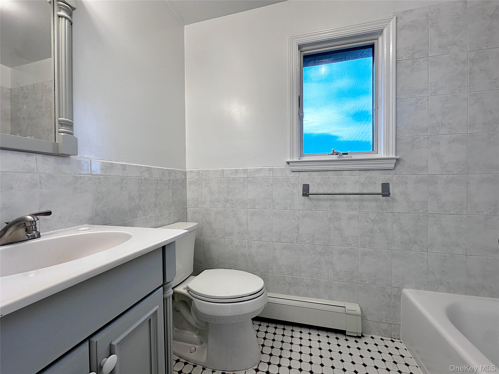 25 Acacia Terrace, Unit 2 New Rochelle, NY 10805 - Photo 19 of 28 a bathroom with a sink a toilet and a bathtub