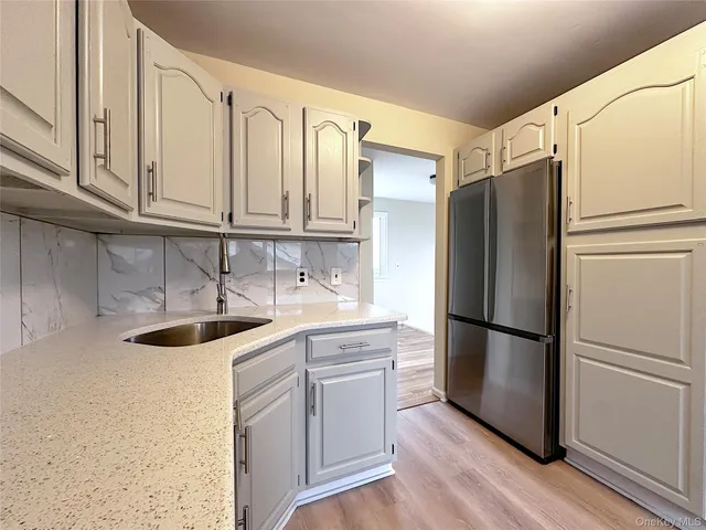 a kitchen with stainless steel appliances granite countertop a refrigerator sink and cabinets