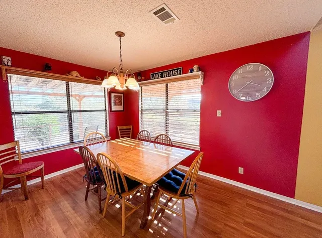 a dining room with furniture window and wooden floor