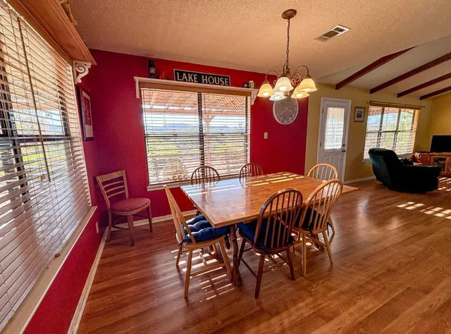 a view of a dining room with furniture window and wooden floor