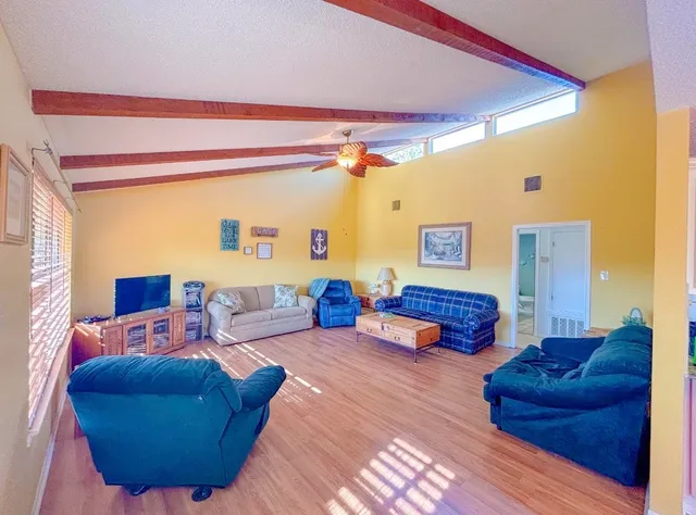 a bedroom with furniture and a large window