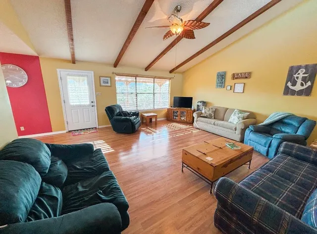 a living room with furniture a couch and a chandelier