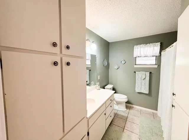 a spacious bathroom with a double vanity sink and a mirror