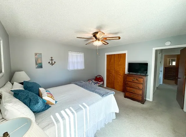 a bedroom with a bed and a tv