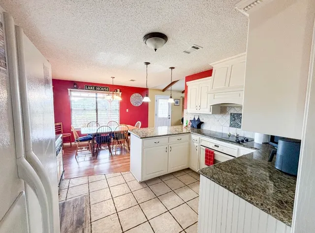 a open kitchen with a sink a stove and cabinets