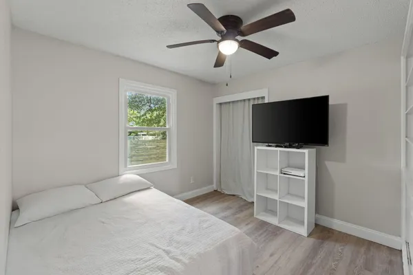 a bedroom with a bed and a window