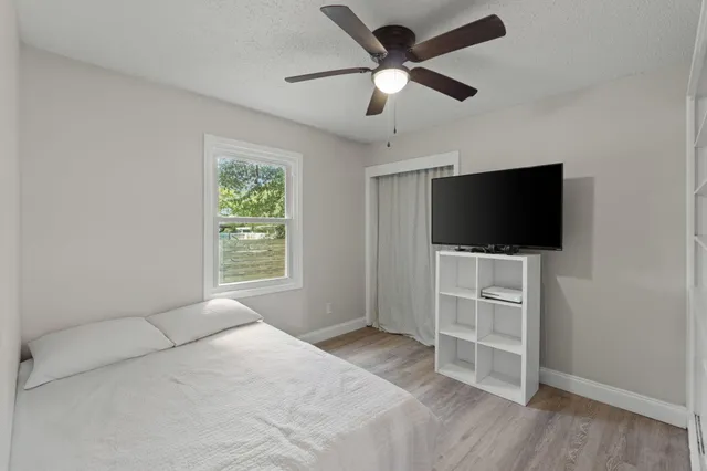 a bedroom with a bed and a window