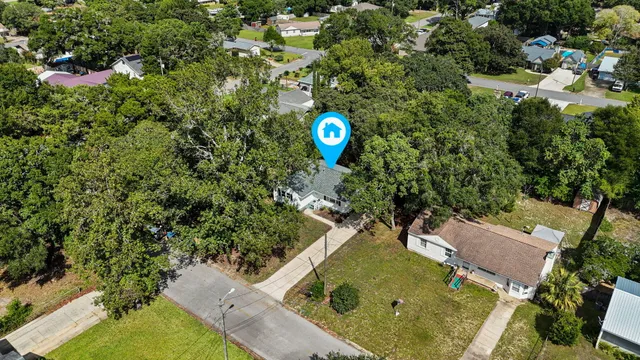 a view of a house with a backyard