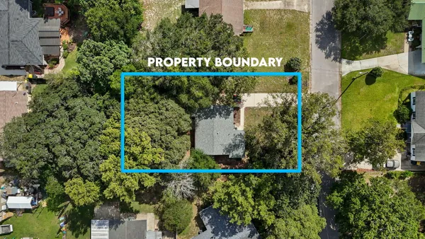 an aerial view of a house with a yard and swimming pool