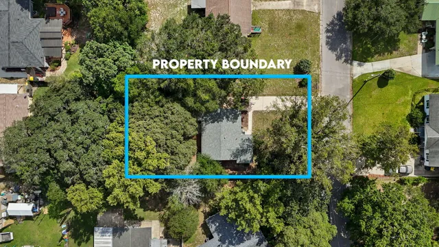 an aerial view of a house with a yard and swimming pool