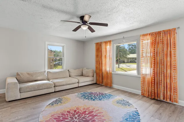 a hallway with wooden floor and a potted plant