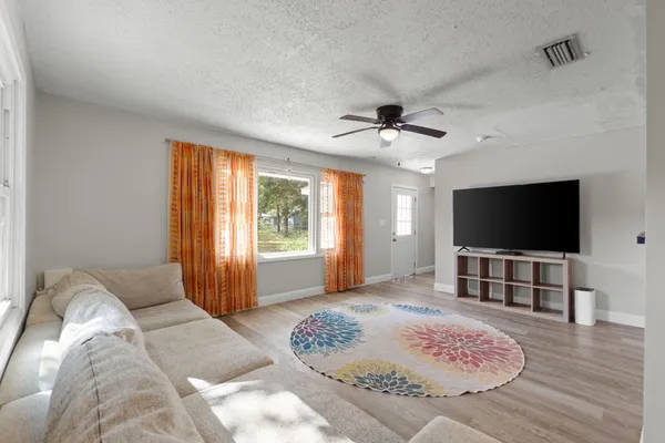 a living room with furniture and a flat screen tv