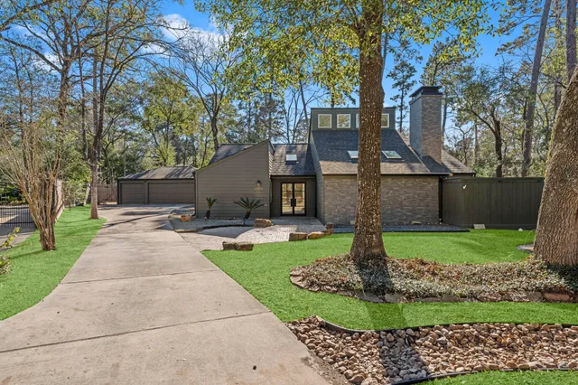 a front view of a house with a yard and a garden