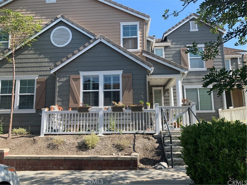 a view of house with a yard and patio