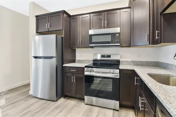 a kitchen with a refrigerator stove and microwave