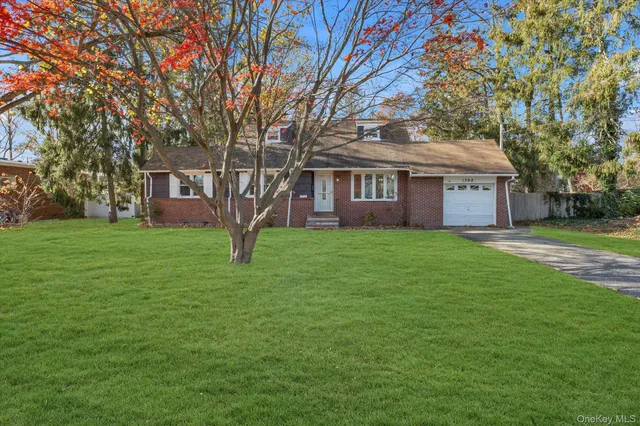 a front view of house with yard and green space