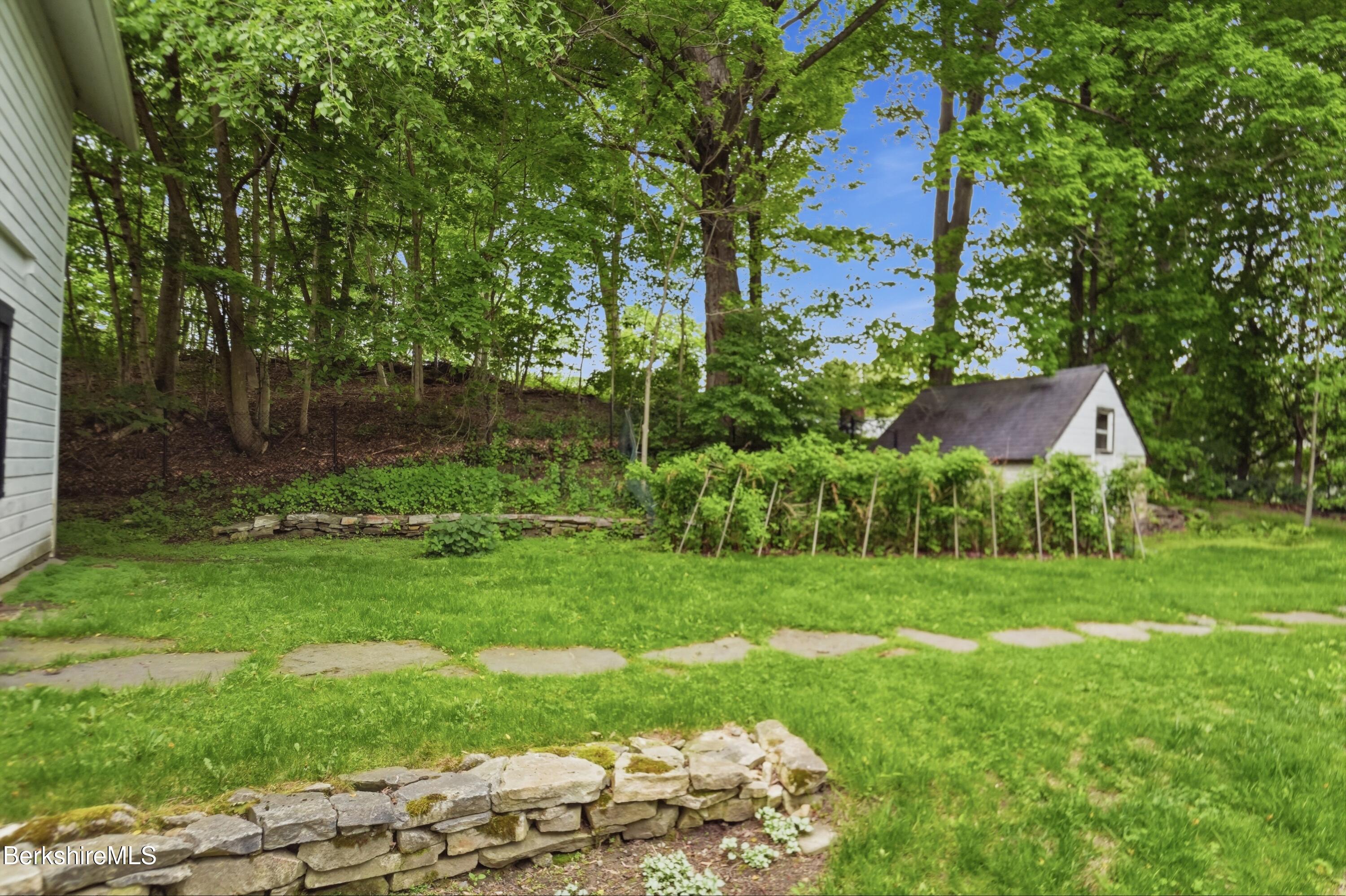 4 Stockbridge Road West Stockbridge, MA 01266 - Photo 87 of 94 a view of a backyard with plants and a lake view
