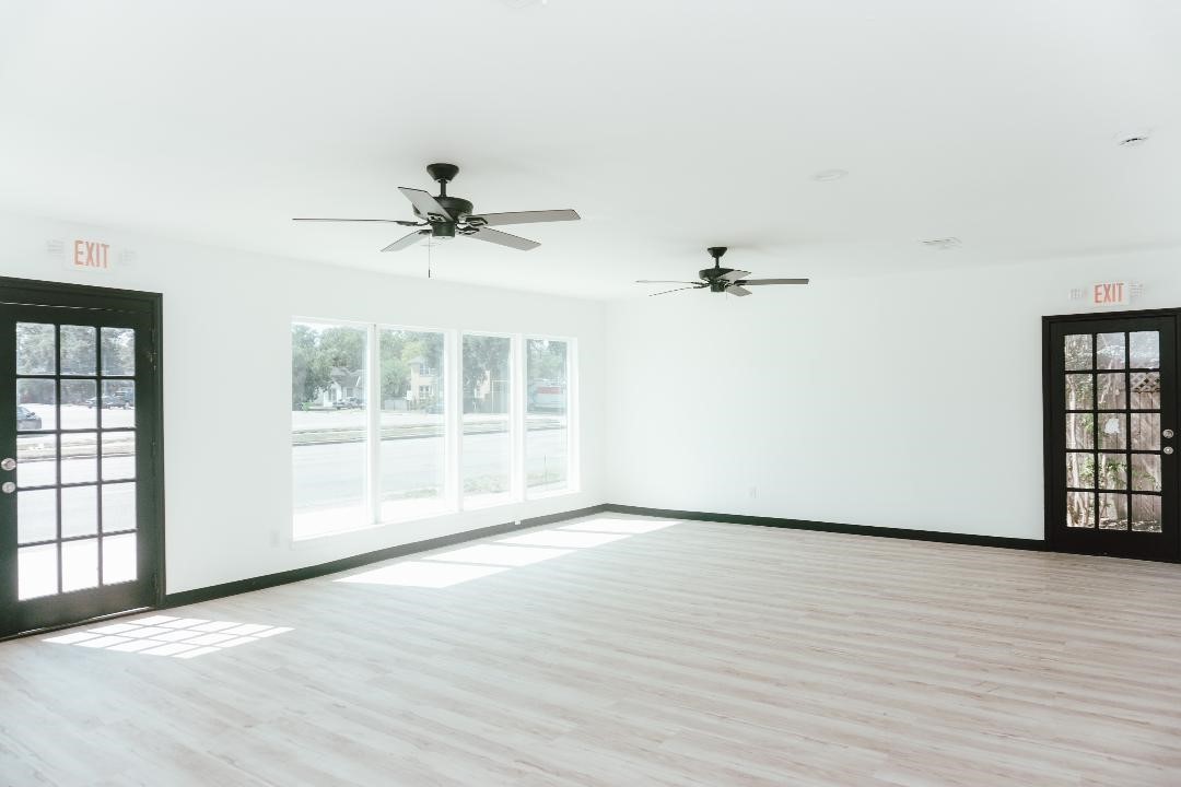 2513 Avenue H Rosenberg, TX 77471 - Photo 3 of 9 wooden floor in an empty room with a window